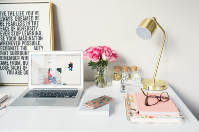 Image of a desk with computer, and other items